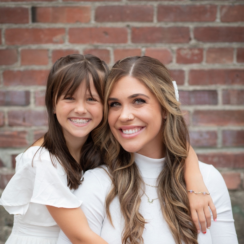 woman with daughter smiling