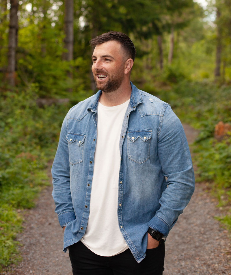 man with braces in the woods