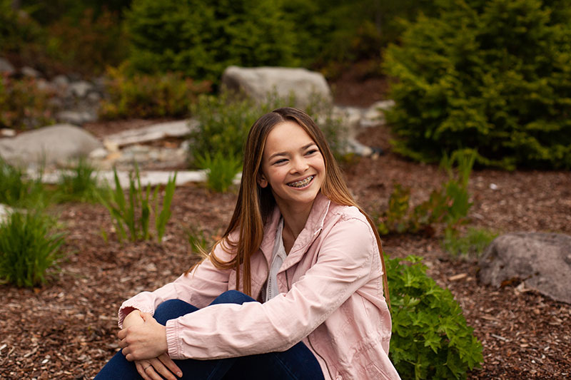girl in pink jacket smiling
